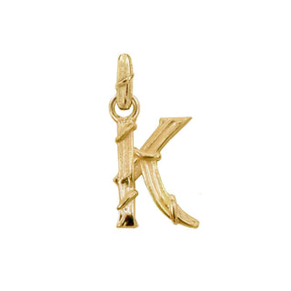 Karen Karch textured 18k yellow gold charm in the shape of the letter 'K' with a vine-detail and rectangular bail on white background.