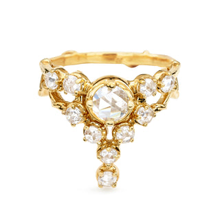 A Karen Karch 18k Yellow Gold ring featuring a round rose cut colorless diamond center stone surrounded by smaller colorless diamonds, in a star-like formation on a white background.