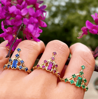 Karen Karch Sapphire, Ruby and Emerald 18k Yellow Gold Tokyo Flaoating Star Rings each on its own finger on hand