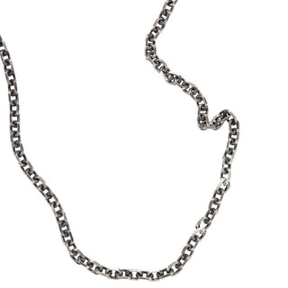 Karen Karch oxidized silver diamond-cut cable chain necklace with a lobster lock clasp and a branded  end tag close up.