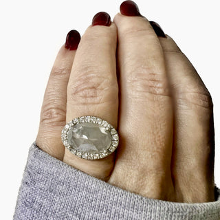 Karen Karch Platinum Bespoke Regal Ring with a Large Rose Cut Gray Diamond set East West with a halo of small colorless Diamonds on a hand.