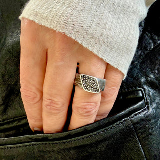 Karen Karch sterling silver Signet Wrap ring studded with black diamonds, 9.5 mm wide on a hand.
