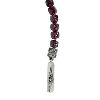Close up of Logo and stamp on sterling Silver Bar and Bead side of Karen Karch Outshine Lariat og garnet faceted cube beads.