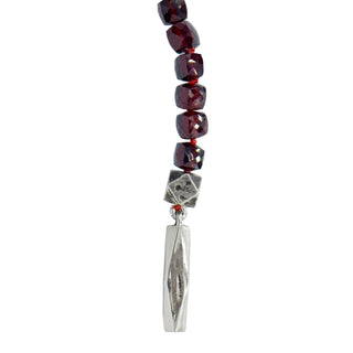 Close up of Sterling Silver Bar and Bead side of Karen Karch Outshine Lariat og garnet faceted cube beads.