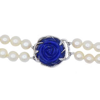 Karen Karch custom carved lapis rose centerpiece clasp on double strand of pearls, close up.