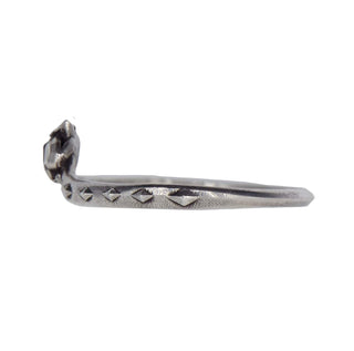 Karen Karch by Deme Wolfe silver snake ring curved to bite its tail, side view.