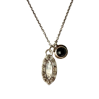 Karen Karch Champagne Diamond Studded Eye Shape Weathered Dog Tag Layered on Silver Cable Chain with Black Onyx Inner Circle Charm on White Background. 