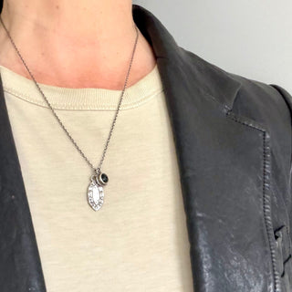 Karen Karch Champagne Diamond Studded Eye Shape Weathered Dog Tag Layered on Silver Cable Chain with Black Onyx Inner Circle Charm on Neck.