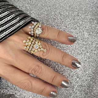 Karen Karch Yellow gold, white gold and platinum diamond rings styled on hand.