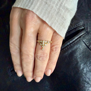 Karen Karch 18k Yellow Gold Diamond Tokyo Floating Star Ring with Baguette Diamond Center Stone and Princess Cut  Diamond in Cluster Shape on hand.