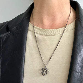 Karen Karch Silver Entwined Heart Amulet on a 22" chain on a person
