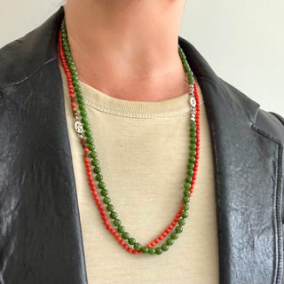 Karen Karch Epitome 4mm Round Red Coral accented with Tigers Eye  Beaded Necklace layered with a 5mm Jade Bead Necklace shown on a person with a t-shirt and leather jacket. 