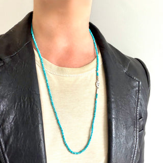 Karen Karch Epitome Faceted Turquoise Bead with Silver Necklace on a Person in a T-shitrt and leather jacket.
