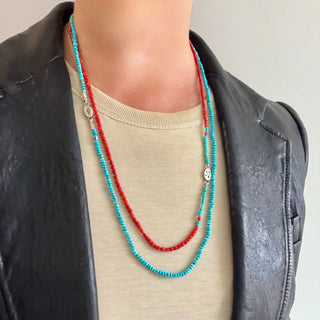 Karen Karch Epitome Faceted Turquoise Bead with Silver Necklace layered with a coral and turquise bead necklace on a person in a T-shitrt and leather jacket.