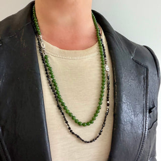 Karen Karch Epitome 5mm Jade Bead Necklace shown layered with a Black Spinel Bead Necklace on a person with a t-shirt and leather jacket. 