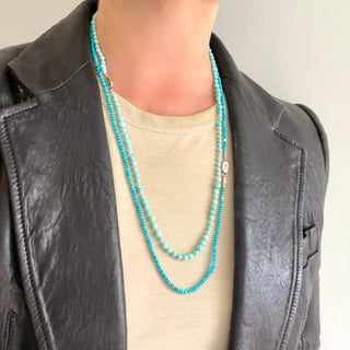Karen Karch 4mm and 5mm Round Mixed Size Turquoise Beaded Necklace layered with a faceted Turquoise bead necklace with a small silver tag engraved with a K-rose logo on a neck.