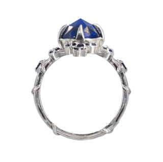 A Karen Karch silver cocktail ring featuring a large round lapis center stone surrounded by smaller lapis stones, in a star-like formation, top view