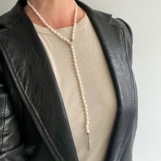 A white freshwater pearl and silver lariat with a weathered texture closure by Karen Karch