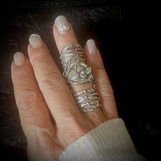 Karen Karch Gabrielle Rose silver knuckle ring with a rosebud that sits over the knuckle that connects to two Gladiator Vine Bands extending the length of the finger on the finger. 