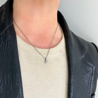 Karen Karch Inner Circe Silver 4mm Green Sapphire Charm on a 1mm chain on a neck.