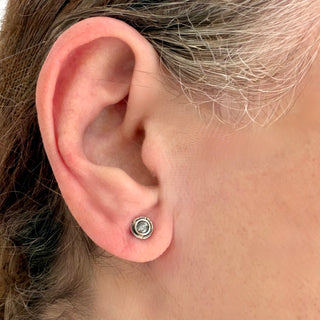 A close-up of an ear with a Karen Karch textured silver Inner Circle Salt & Pepper Grey diamond stud earrings.