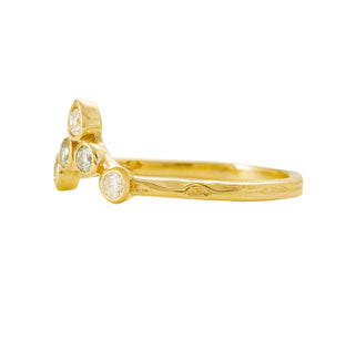 Side view of aKaren Karch 18k Yellow Gold Ring with 5 bezel-set Colorless Diamonds arranged in the shape of a simplified tiara on a thin weathered band, 