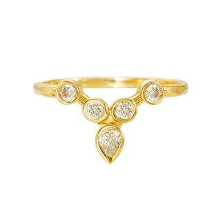 Karen Karch 18k yellow gold tiara ring featuring bezel-set round diamonds arranged to create a "v" shape. This configuration is crowned with an outward pointing pear-shape bezel. The weathered precious metal shank measures 1.6mm.