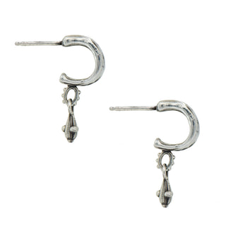 Side view of a Pair of Karen Karch silver Jaipur Mainstay hoop earrings with small metal drops on a white background