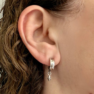 Karen Karch Jaipir Mainstay Silver hoop earrings, with a drop shown on an ear. 