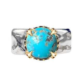 A Karen Karch weathered silver wide band ring featuring a large round turquoise cabochon in a gold claw setting, studded with Black Diamonds and Rubies around the base shown against a plain white background.
