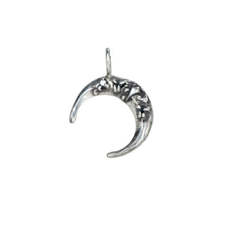 Silver crescent moon pendant with raised silver shapes and black diamonds on a white background