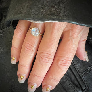 Karen Karch by Deme Wolfe 10k Yellow Gold Mystical Solitaire 9mm Rainbow Moonstone Riing on a hand.