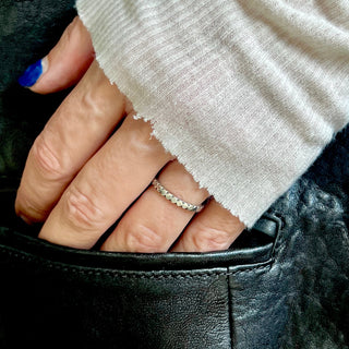 Karen Karch Outshine 2.1 mm wide silver ring with repeating square pattern on hand 