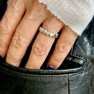 Karen Karch Outshine 3.8mm polished silver ring with a repeated angular pattern on a hand.