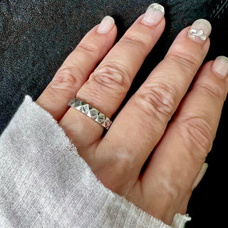 Karen Karch Outshine Weathered silver 5mm band with a textured, angular repeating pattern design on a hand,