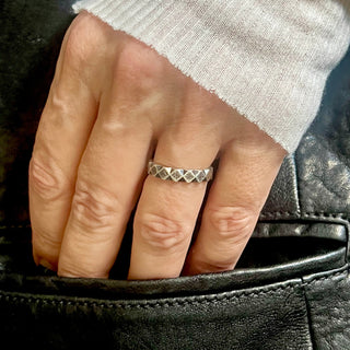 Karen Karch Weathered Outshine 3.85 mm wide silver ring with texture and geometric angular pattern on hand
