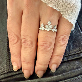 Karen Karch Platinum Bezel-set Diamond Belgian Tiara Ring with 8 round diamonds configured in the shape of a tiara with 3 pear shape settings at  the top row on a  hand.
