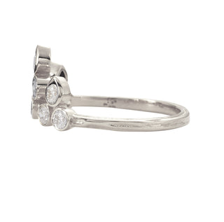 Side view of a Karen Karch Platinum Side view of a bezel-set Diamond Belgian Tiara Ring with 8 round diamonds configured in the shape of a tiara with 3 pear shape settings at  the top row on a white background. 
