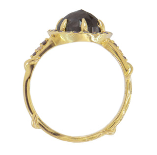 Top view of a Karen Karch 18k Yellow Gold Dark Grey Oval Diamond ring surrounded by a order of black and white diamonds. There are 3 diamonds each side of center on the band.  