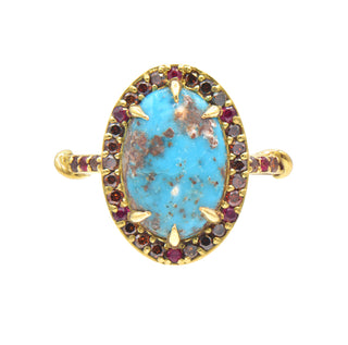 Karen Karch Regal Ring in 18k yellow gold with a matrix turquoise oval stone with a halo of small cognac diamonds and rubies set against a white background