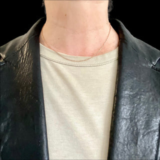 Karen Karch Rose Gold Twinkle Chain on the neck.