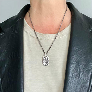 Karen Karch Rose Tattoo Dog Tag in Silver On Chain on model in black leather jacket.