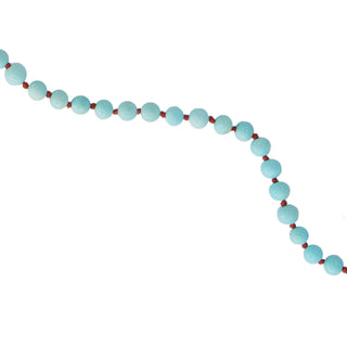 Close up of a Necklace with turquoise beads with a hot pink knot between each on a white background