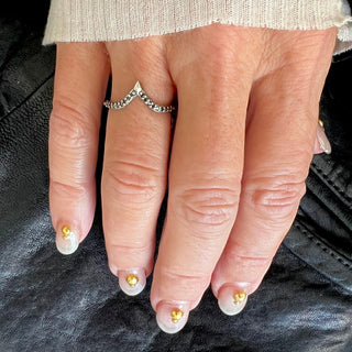 Karen Karch by Deme Wolfe Royal Dune Ring in silver with black diamond on front of band, point facing upward, on a hand,