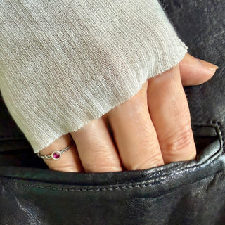 Karen Karch Silver Vine Stacker with a bezel-set ruby on a hand.