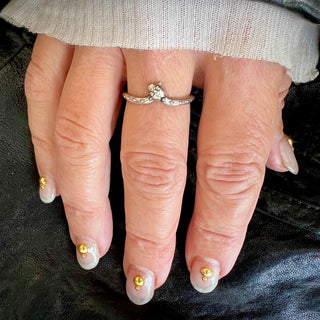 Karen Karch by Deme Wolfe silver snake ring curved to bite its tail on hand.