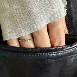 Karen Karch Silver Vine Stacker Ring with a bezel-set green sapphire on a hand.