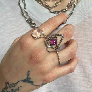 Karen Karch Jaipur Rose Tattoo  Sterling Silver Ring with a Pear shape center stone held by claws styled on a hand with other silver rings. 