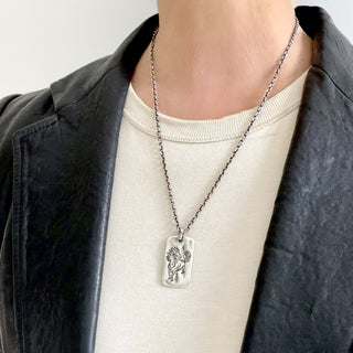 KAREN KARCH LEGEND FIRE HORSE TAG Sterling Silver on a 2.6mm Diamond Cut VCable Chain on a person.