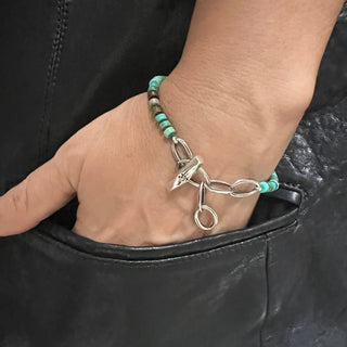 Karen Karch Silver Weathered Toggle Oval Link Adjustable length Turquoise heshi bead bracelet on wrist.